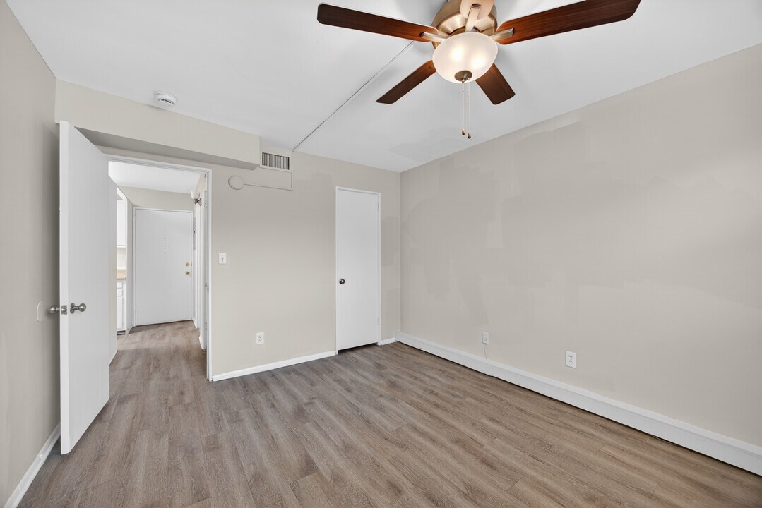 Bedroom with wood-look flooring and ceiling fan